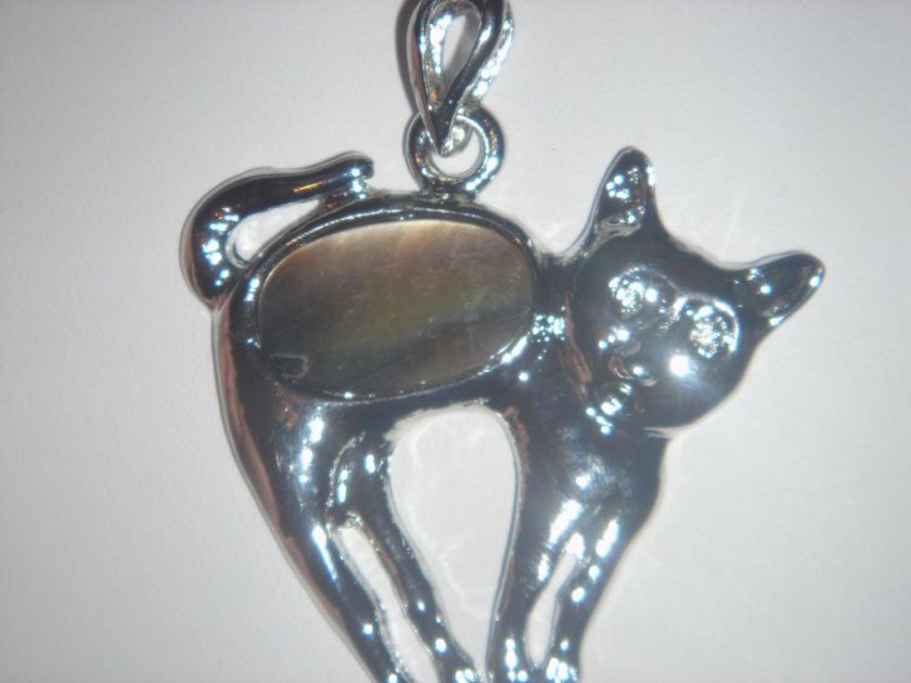 This is a pretty and fun amulet with an oval black lip shell in the 